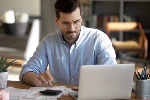 Männliche Fachkraft arbeitet zuhause am Laptop